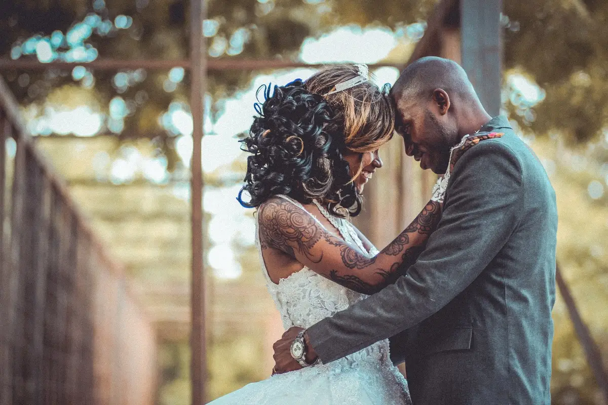 couple posting for photos before enjoying music for outdoor wedding